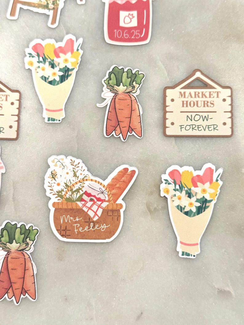 May include: A collection of colorful stickers featuring a market theme. Designs include bouquets of flowers, carrots, a picnic basket with bread, and a sign that reads "MARKET HOURS NOW-FOREVER". The stickers are in various shapes and sizes.