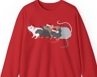 May include: A red sweatshirt featuring a graphic of four mice wearing Santa hats. The mice are in various colors: white, black, brown, and gray. The sweatshirt is a solid red color.