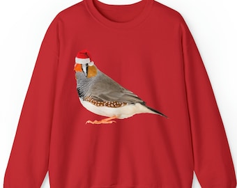 Könnte beinhalten: Roter Pullover mit einem grau-weißen Vogel, der eine rote Weihnachtsmütze trägt.