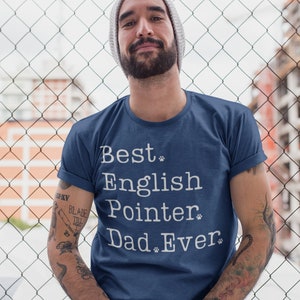 May include: A man wearing a blue t-shirt with the text "Best English Pointer Dad Ever" printed in white. The text is in a typewriter font and includes paw prints.