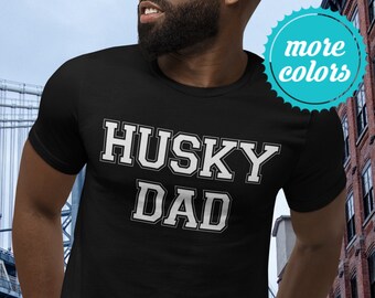 May include: Black t-shirt with white text that reads "HUSKY DAD".