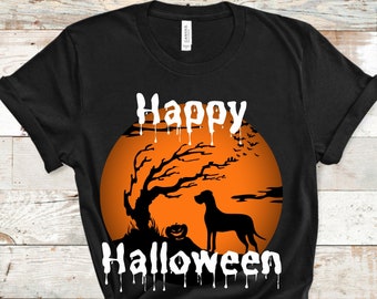 May include: Black t-shirt with a Halloween design. The design features a silhouette of a dog, a tree, and a pumpkin in front of an orange moon. The words "Happy Halloween" are written in white, with a dripping effect.