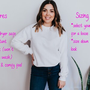 May include: A white unisex sweatshirt with long sleeves. The image includes text describing features like unisex fit, washer and dryer safe, pilling resistant, pre-shrunk, and a super soft feel. Sizing tips are also provided.