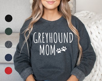 May include: A dark gray sweatshirt with the text "Greyhound Mom" and two white paw prints.