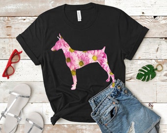 May include: Black t-shirt with a floral print of a Doberman Pinscher dog silhouette.