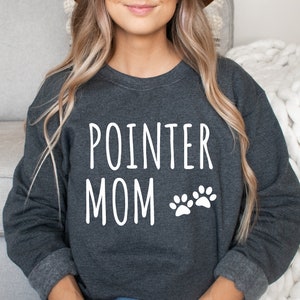 May include: A dark gray sweatshirt with the text "POINTER MOM" and two white paw prints.
