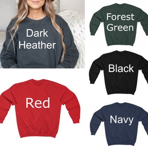 May include: Five crewneck sweatshirts in different colors: dark heather, forest green, black, red, and navy. Each sweatshirt has the color name printed in white on the front.