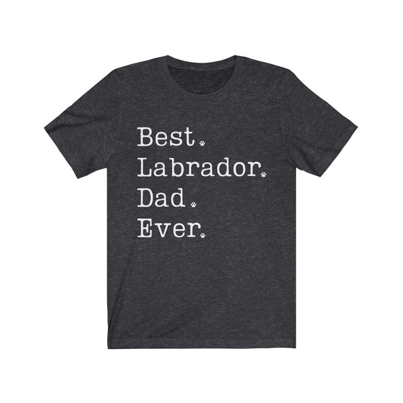 May include: Dark heather grey t-shirt with white text that reads "Best Labrador Dad Ever."  The text is surrounded by small paw prints.