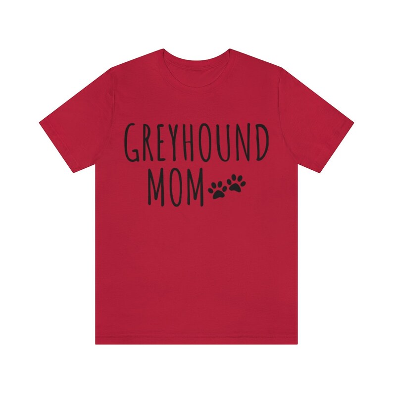 May include: Red short-sleeved t-shirt with the text "Greyhound Mom" and two black paw prints.