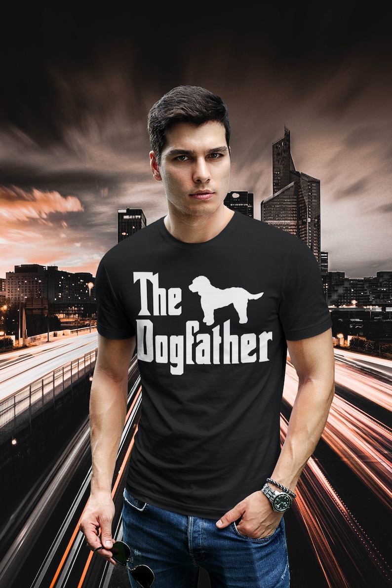 May include: A black t-shirt with a white graphic of a dog and the text "The Dogfather".