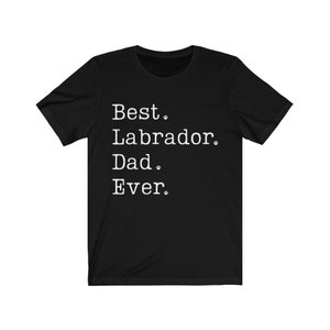 May include: Black t-shirt with white text that reads "Best Labrador Dad Ever."  The text is in a typewriter font and includes paw prints.