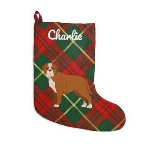 May include: Christmas stocking with a red, green, and yellow plaid pattern. A brown and white dog illustration is featured on the stocking. The name "Charlie" is written in white script across the top.