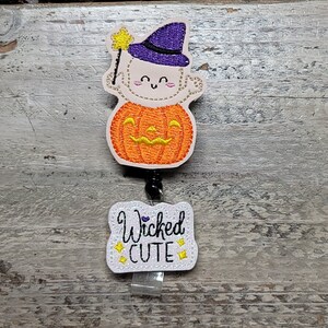Wicked Cute Baby in Pumpkin | purple and black hat | halloween badges | labor and deliver | L&D | NICU | mother baby | newborn | peds | RN