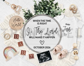 May include: A white letter board with the text "When the time is right, I, The Lord will make it happen. October 2026."  A white onesie with the text "Baby Josh" and a heart. A rainbow-colored yarn rainbow, wooden blocks spelling "BABY", a wooden rattle, a wooden sign with the text "Hello World", and a sonogram image.