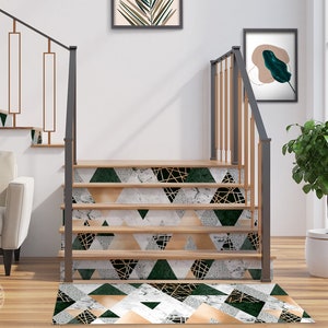 May include: A set of stairs with a green, gold, and white geometric patterned runner. The runner has a marble-like design with gold accents. The stairs are made of wood and have a black metal railing.