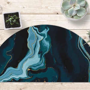 May include: A half-circle rug with a blue and gold marble pattern. The rug has a dark blue background with swirling light blue and gold accents.