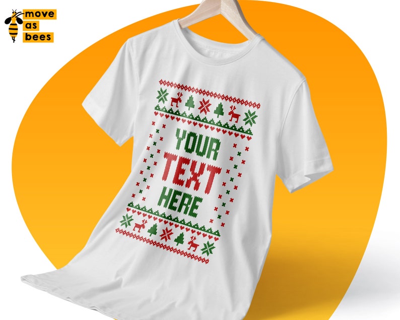 May include: White t-shirt with a red and green Christmas sweater design. The design includes snowflakes, reindeer, and Christmas trees. The text "YOUR TEXT HERE" is in the center of the design.