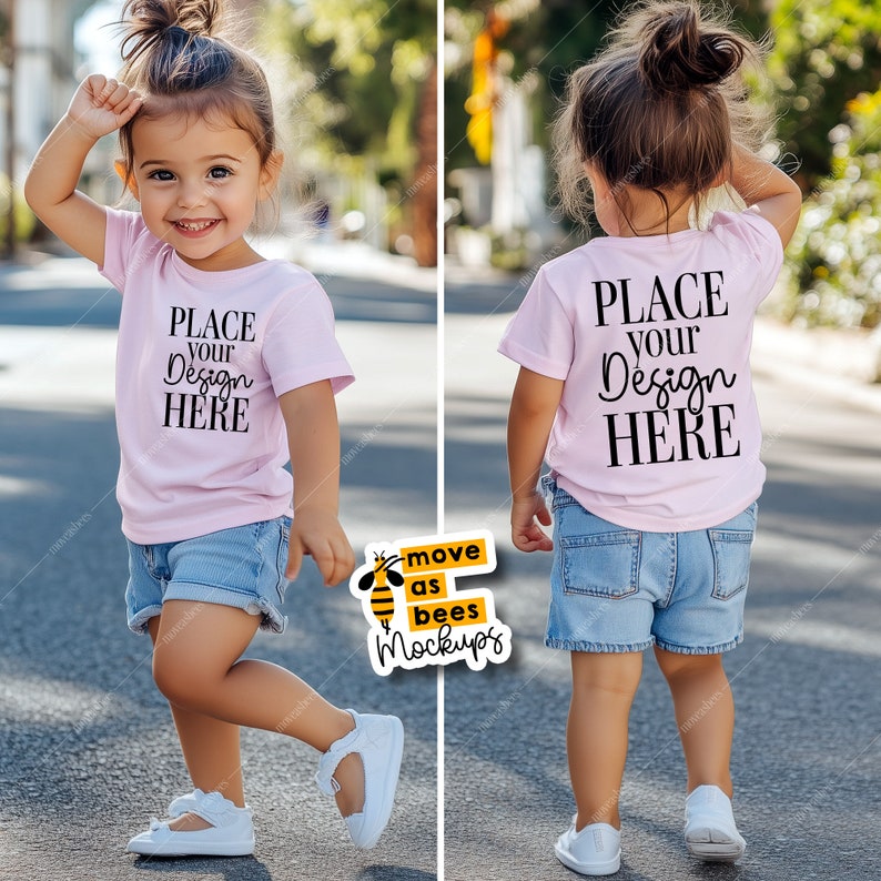 May include: A pink toddler t-shirt mockup with the text "PLACE YOUR DESIGN HERE" on the front and back. The shirt is being worn by a child standing on a paved street.