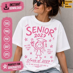 May include: White t-shirt with pink graphics, including the word "SENIOR" above "2027" and a stick figure graduate. Additional text includes "we did it(ish)", "now what?", and "Class of 2027".
