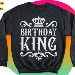 May include: Black sweatshirt with a white crown and the text "Birthday King" in a decorative font.