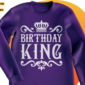 May include: Purple sweatshirt with a white crown and the text "Birthday King" in a decorative font.
