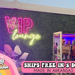 May include: A neon sign that reads "VIP lounge" in pink and green against a green wall. The image includes a doorway with people and a logo for "Two Lit Avocados".