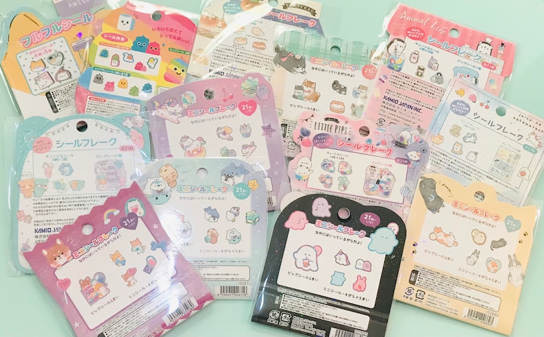 May include: A collection of 10 colorful sticker sheets featuring various cartoon characters. Each sheet has a different theme, including animals, food, and everyday objects. The stickers are perfect for adding a touch of whimsy to journals, planners, and other items.