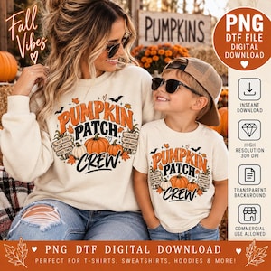 May include: A cream-colored sweatshirt and t-shirt set featuring a graphic print with the text PUMPKIN PATCH CREW, orange and white pumpkins, autumn leaves, and small bats. The design includes signs labeled HAY RIDES, CORN MAZE, and GOOD TIMES.