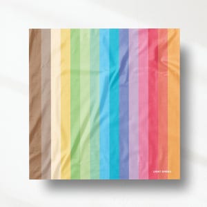 May include: A square fabric swatch featuring a vertical striped pattern in a gradient of colours including brown, cream, yellow, green, blue, purple, pink, and orange. The text LIGHT SPRING is printed in white in the bottom right corner.