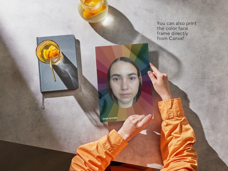 May include: A person holds a color palette with a woman's face in the center. The palette has a rainbow design with the text "Dark Autumn" at the bottom. The text "You can also print the color face frame directly from Canva!" is visible in the background.