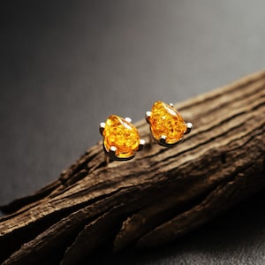 Large amber drop earrings. Sterling silver with natural honey Baltic amber. Gently framed studs. Minimalistic, elegant and eye-catching.