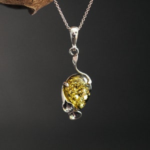 Unique Calla floral pendant with amber. Inspired by calla flower, made of 925  silver and natural Baltic cognac and green amber.