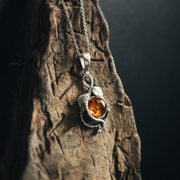 Beautiful floral pendant with amber. Inspired by plants, made of 925 sterling silver and natural Baltic amber. Timeless elegant design.