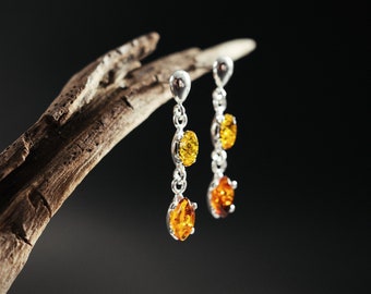 Baltic amber dangle earrings. 925 sterling silver. Marquise cut, beautiful shiny stones.  Two colors of amber. Elegant and eye-catching.