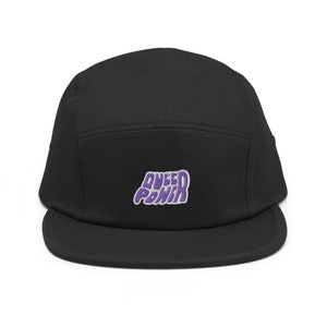 May include: Black 5-panel cap with a purple embroidered logo that says "Quest Ponkin"