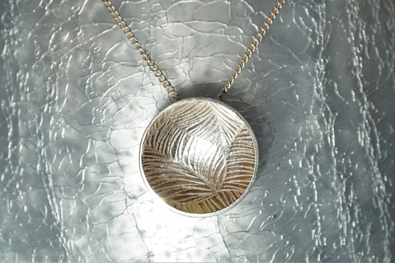 Circular leaf texture dome pendant featuring 925 sterling silver
