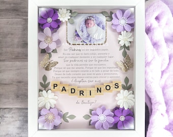 Puede incluir: Un marco blanco con una foto de bebé, rodeado de flores de papel moradas y blancas y mariposas doradas. El texto en español dice: "¿Quieren ser mis padrinos?"