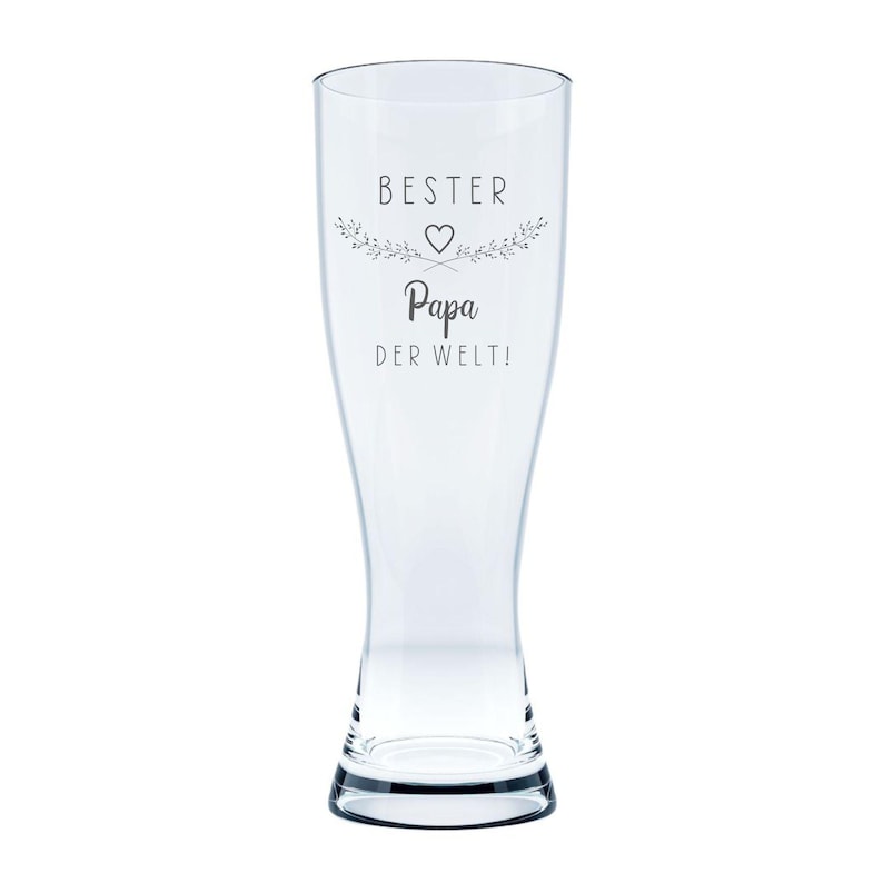 May include: A clear pilsner glass with a flared top and a sturdy base. The glass features the text "BESTER Papa DER WELT!" in a decorative font, with a heart and floral accents. Ideal for beer.