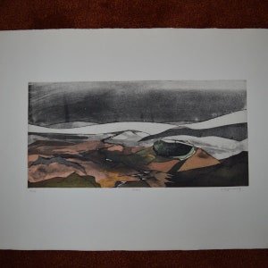 May include: A black and white landscape print featuring a green and brown crater in the centre. The print is titled "Anne" and signed "Gary Jennings".
