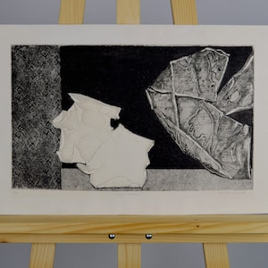 May include: Black and white abstract print with a textured, geometric design. The print features a white shape on the left and a black shape on the right.