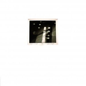 May include: A black and white abstract print featuring a vertical white line and several white circles. The print has a textured appearance and is framed in a white mount.