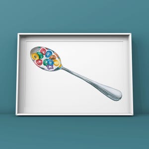 May include: A silver spoon filled with colorful cereal rings. The spoon is on a white background.