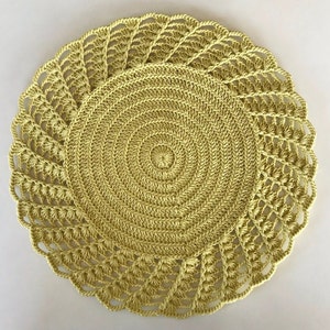 May include: A yellow crocheted doily with a circular design. The doily has a delicate lace pattern around the edge.