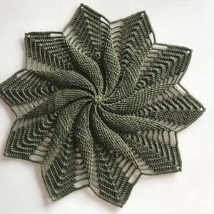 May include: A green crocheted doily with a starburst design.