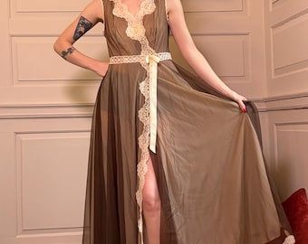 May include: A vintage brown sheer robe with white lace trim and a matching belt. The robe has a high slit and is paired with red shoes. A pink turban is worn on the head. The robe is a vintage piece.