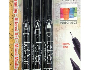May include: Three black LePen Permanent markers with alcohol-based ink. The markers are packaged in a clear plastic sleeve with a white background. The packaging features the LePen logo and the text "Permanent". The packaging also includes a description of the markers' uses, such as journaling, altered art, mixed media, and outlining. The packaging also includes a description of the markers' ink, which is alcohol-based.