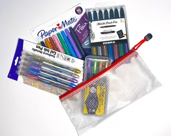 May include: A variety pack of writing tools including a set of seven metallic black brush pens, a set of five metallic gel ink pens, and a set of six multi-colored gel ink pens. The pens are arranged on a white surface with a clear plastic mesh bag.