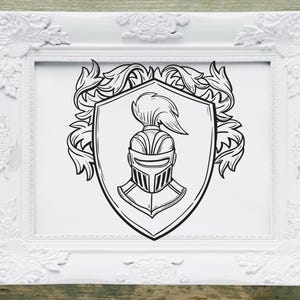 May include: A black and white illustration of a knight's helmet inside a shield with a decorative border of leaves. The image is framed in a white ornate frame.