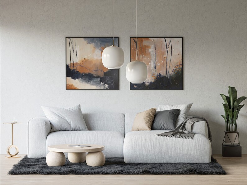 Peut inclure: Un canap&eacute; sectionnel blanc avec deux coussins et une couverture se trouve devant un mur avec deux tableaux abstraits et une plante en pot. Une table basse ronde &agrave; trois pieds se trouve devant le canap&eacute;.