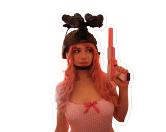 May include: A woman with pink hair wearing a military helmet with night vision goggles and a pink toy gun. She is wearing a pink and white gingham dress.